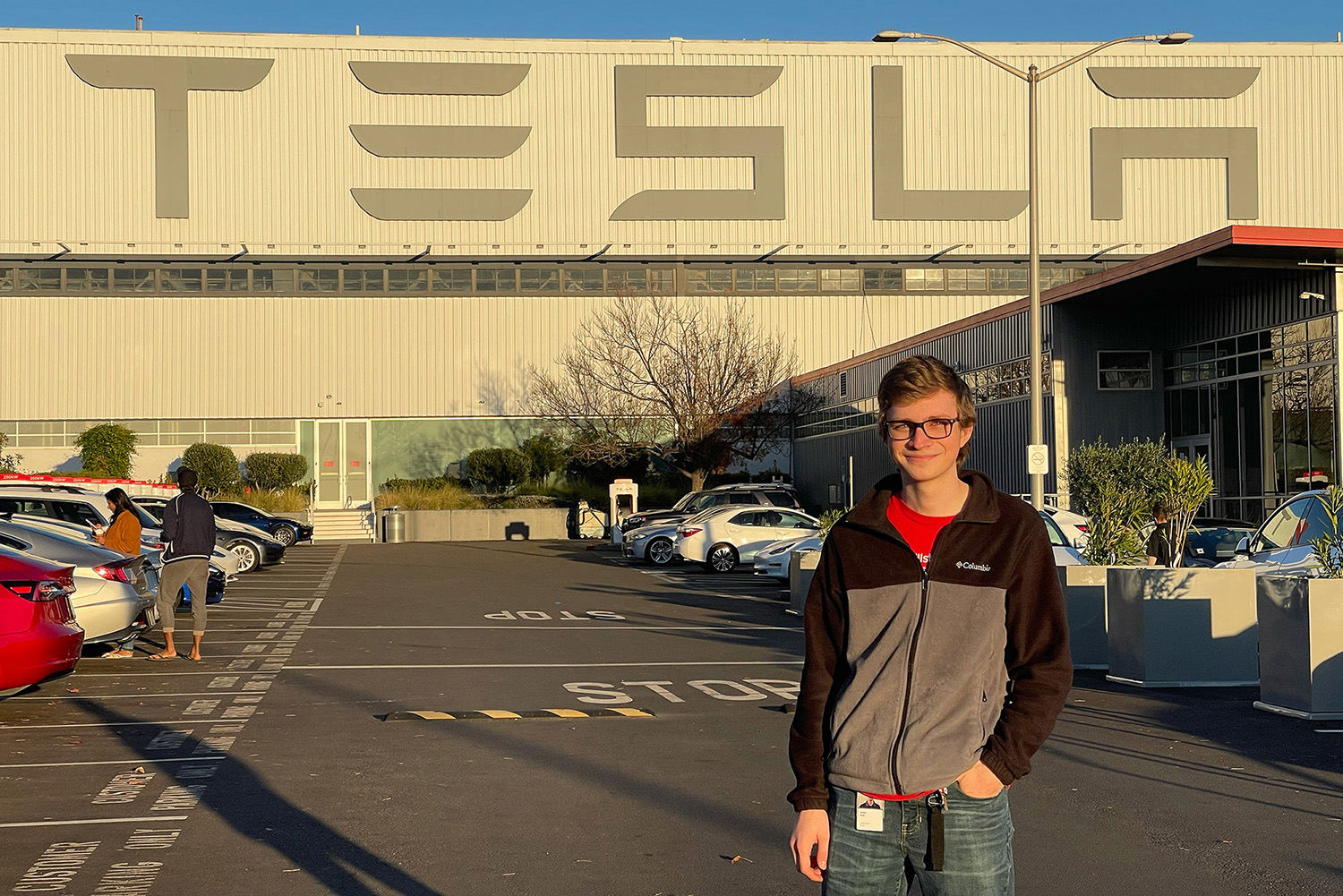 Jackson Glozer stands in front of a Tesla sign while on co-op there.