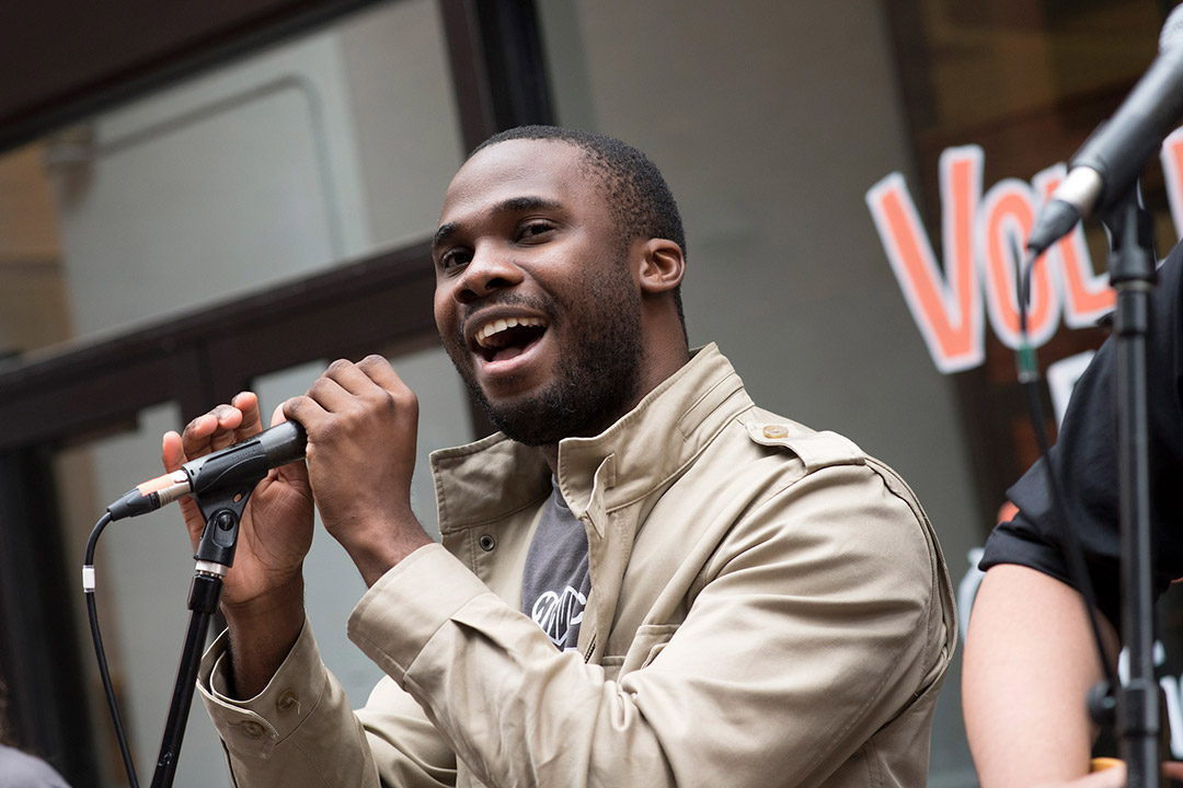 student singing into a microphone.