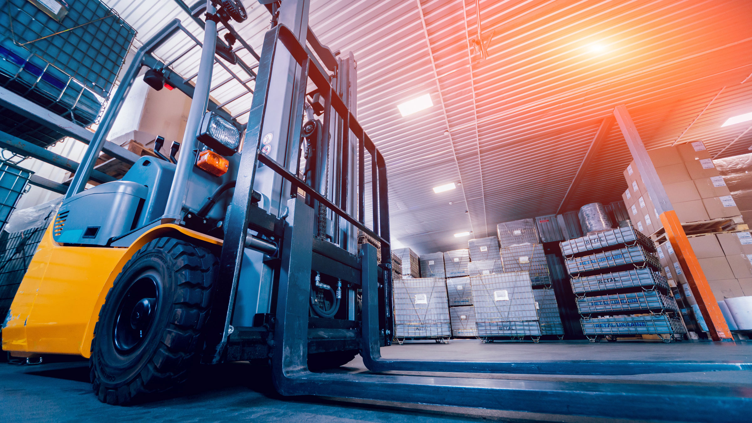 A forklift awaits inventory in a warehouse