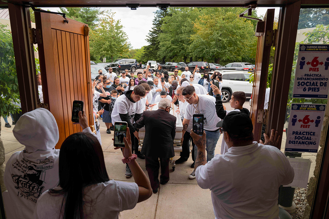 people bringing a casket into a chapel.