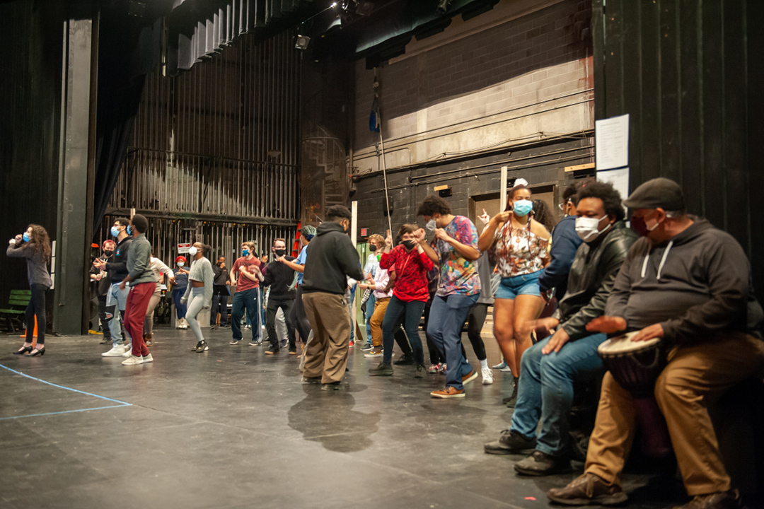 performers on stage rehearsing In the Heights.