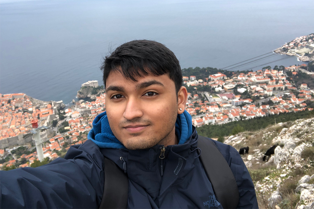 student standing on a mountain overlooking the city of Dubrovnik.