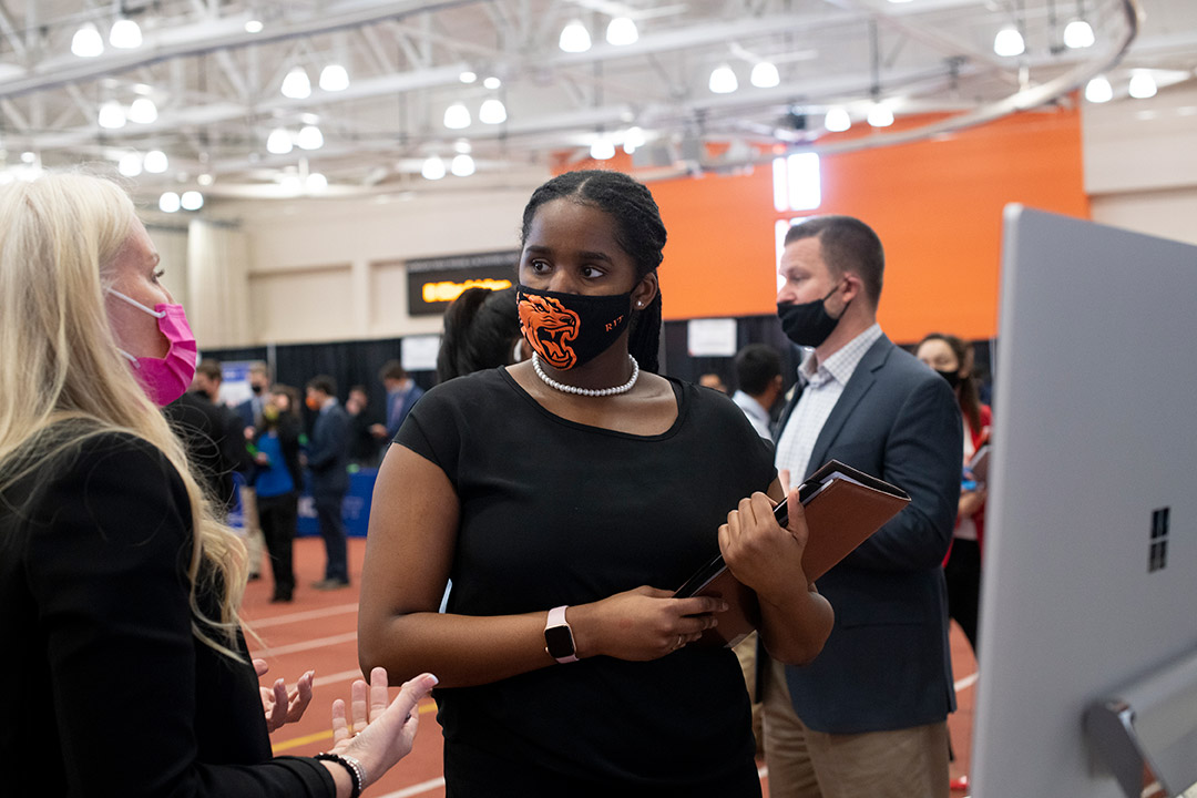 student and employer meeting at a career fair.