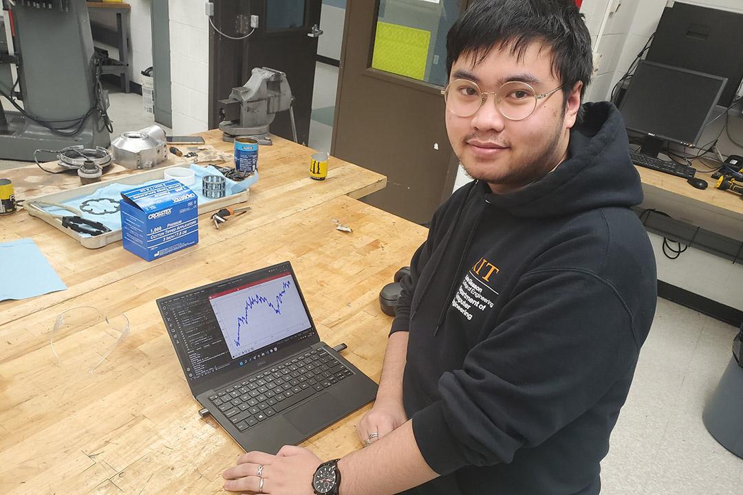 student in a lab working on a laptop.