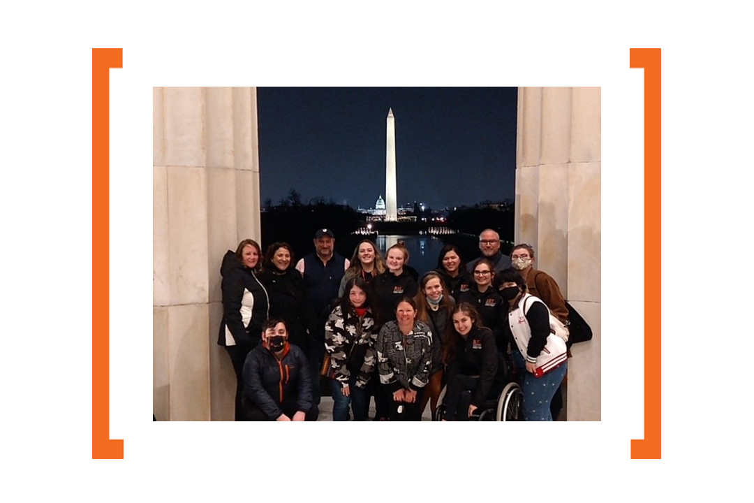 Students in front of Washington Monument at night
