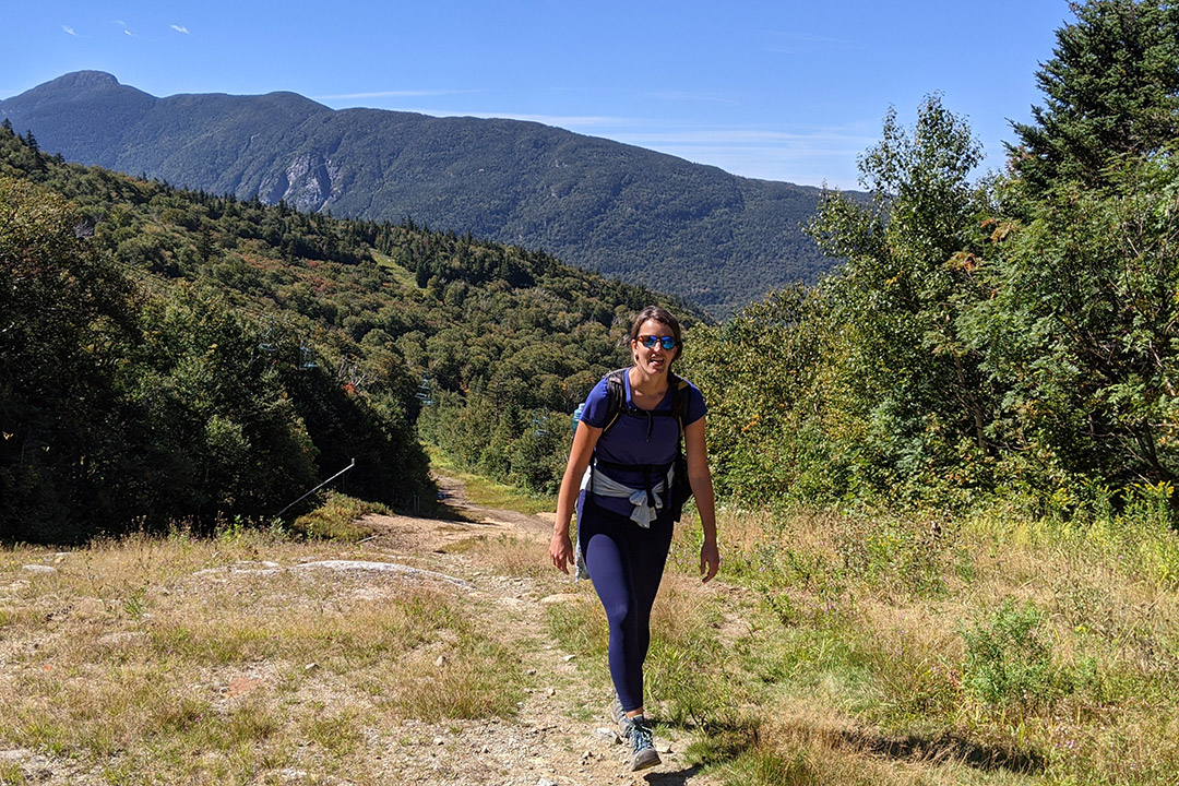 woman on a hiking trail in the mountains.