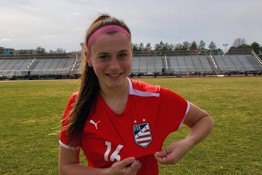 soccer player showing the USA patch on her uniform.