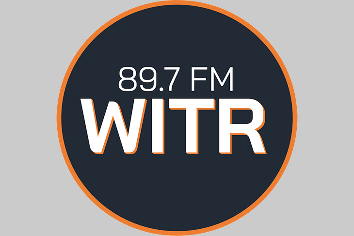 radio station logo with white letters and orange rim