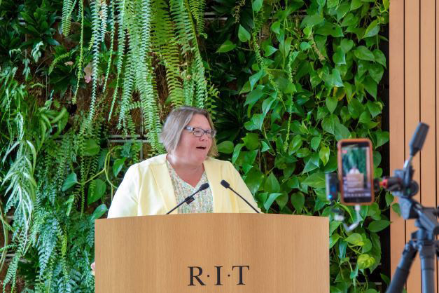 woman speaking at podium.