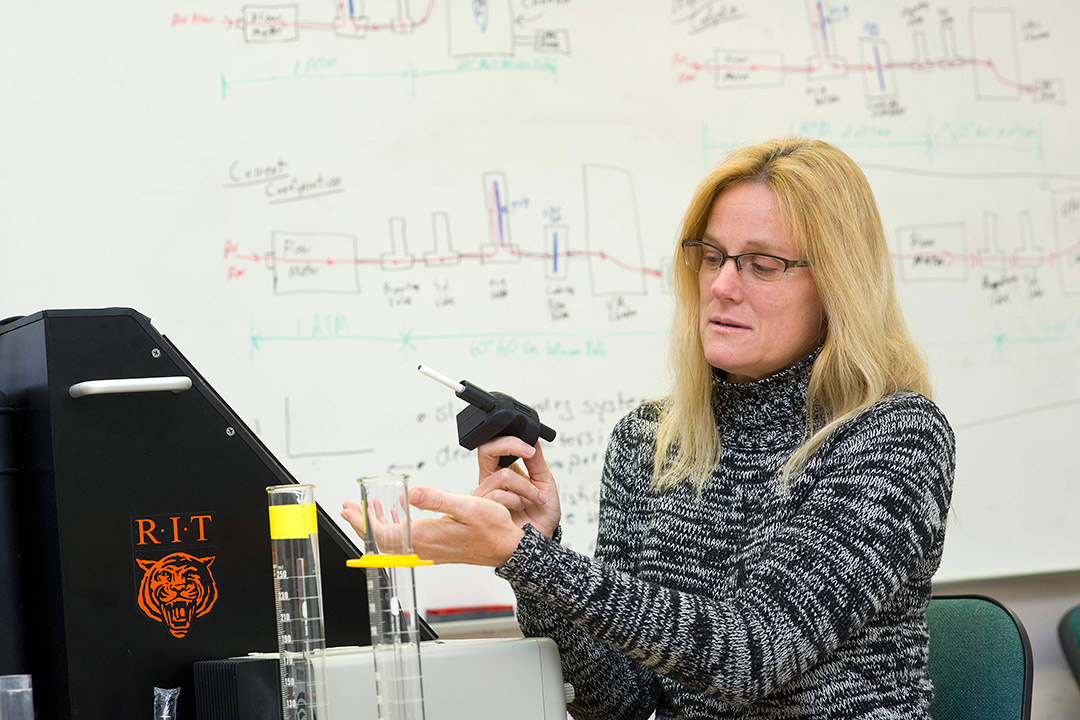 researcher demonstrating device that simulates smoking a cigarette.