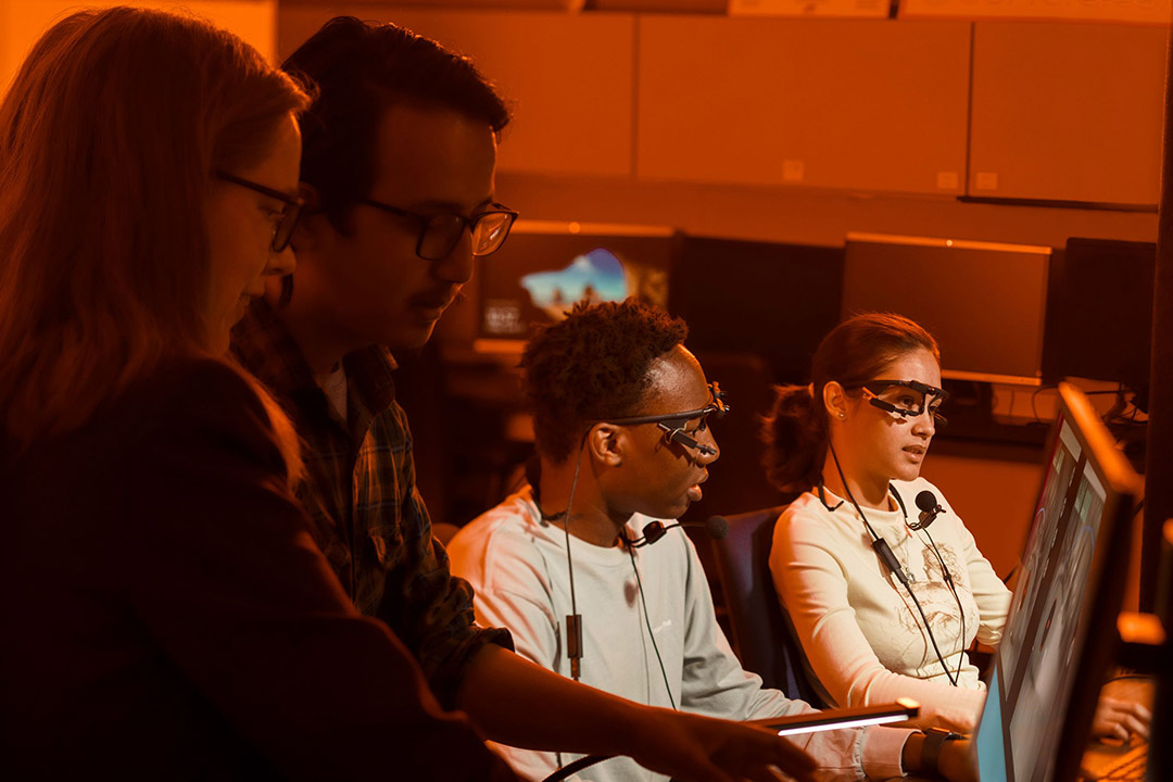 researchers wearing head sets and eye-tracking glasses.