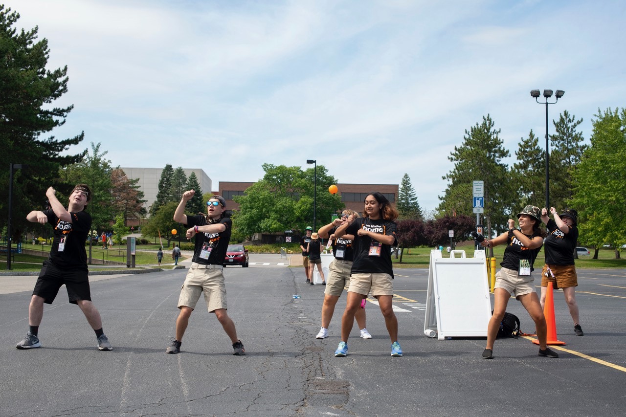 Five students dancing as part of event fun and welcome