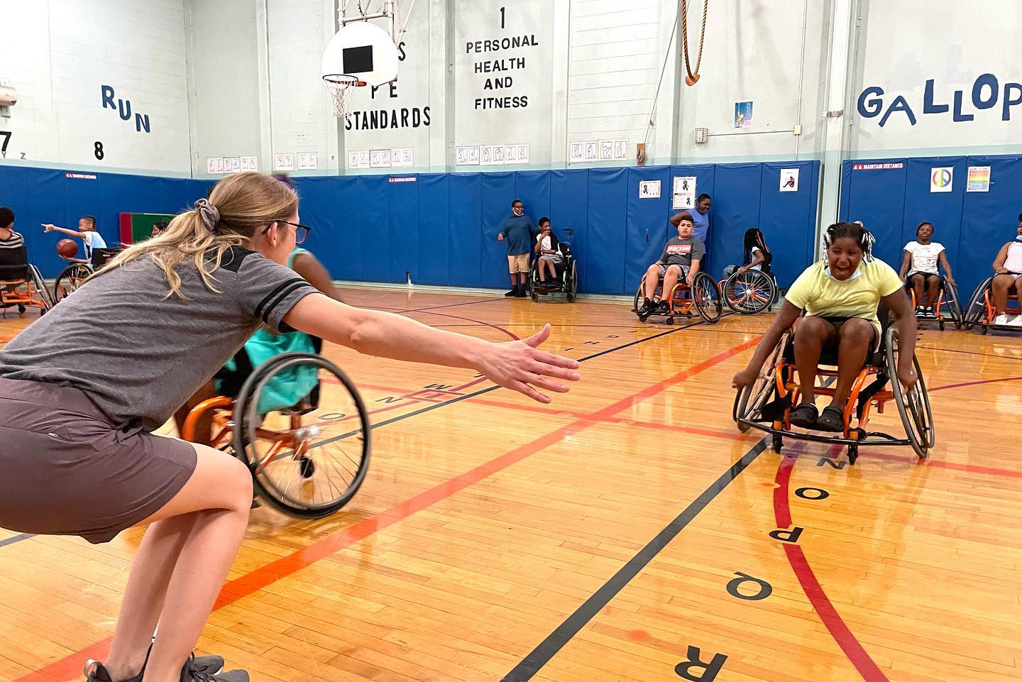 Caralie Fennessey interacts with participants of an inclusive basketball game.