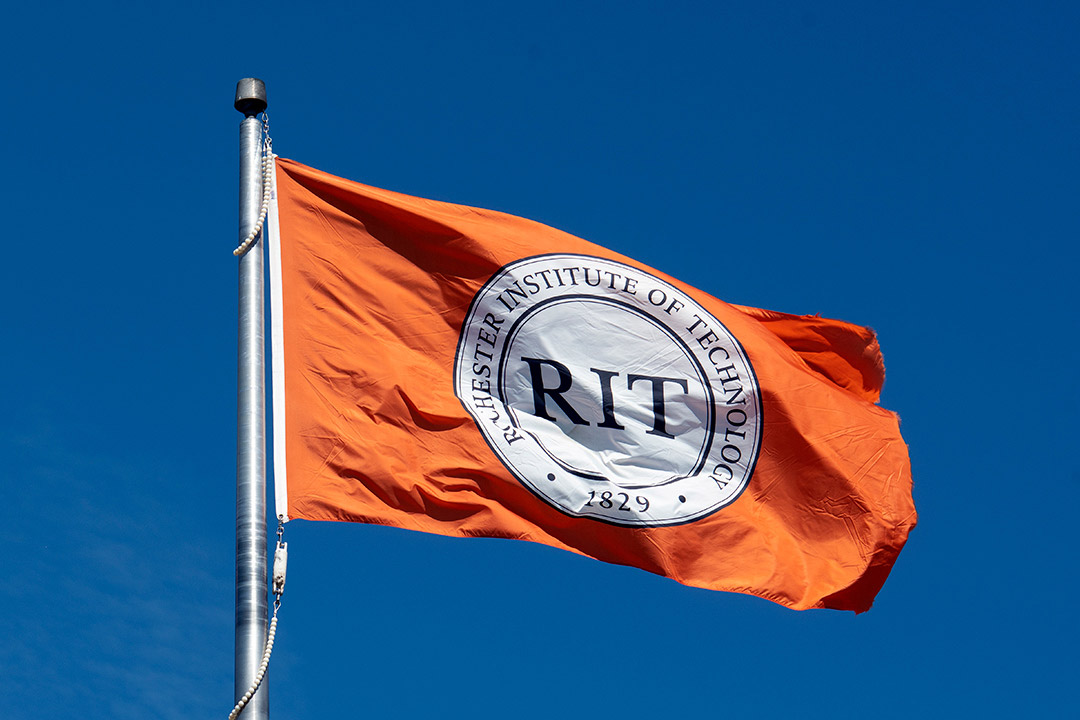 an orange flag with the RIT seal.