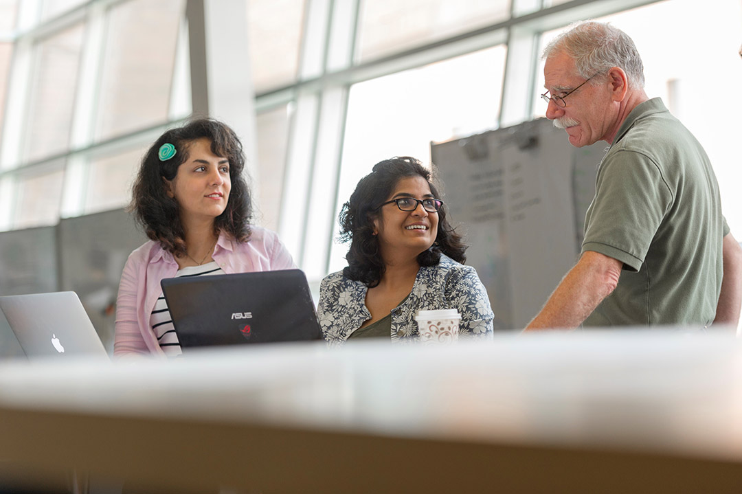 two students looking at a professor.