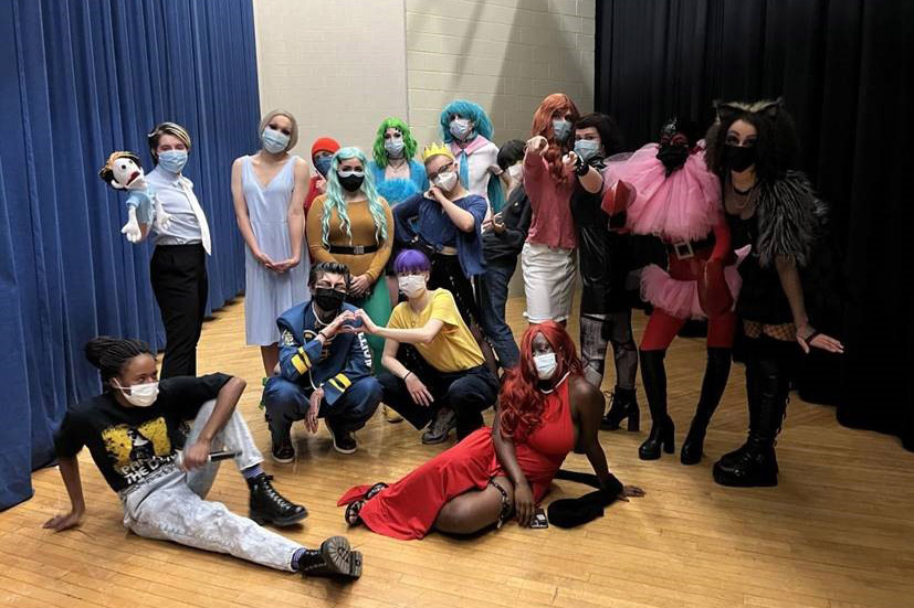 group of 16 students dressed in various forms of drag.