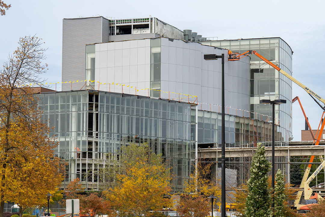 exterior of a multi-story glass building under construction.