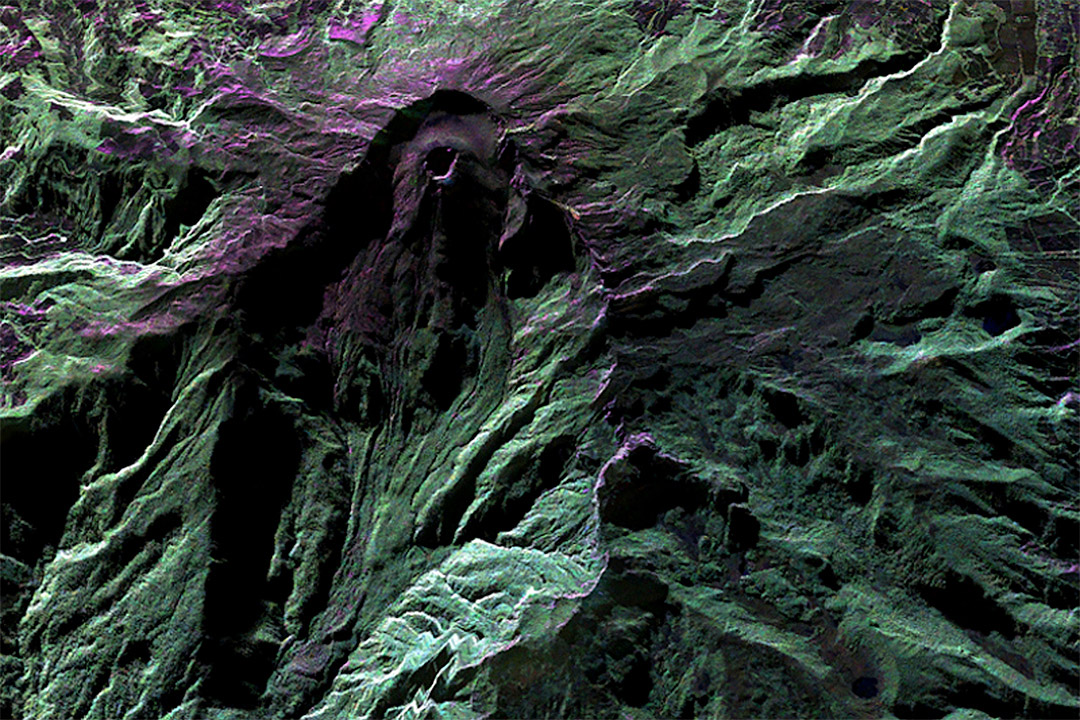 Green and purple-colored image of Colombia’s Galeras Volcano.