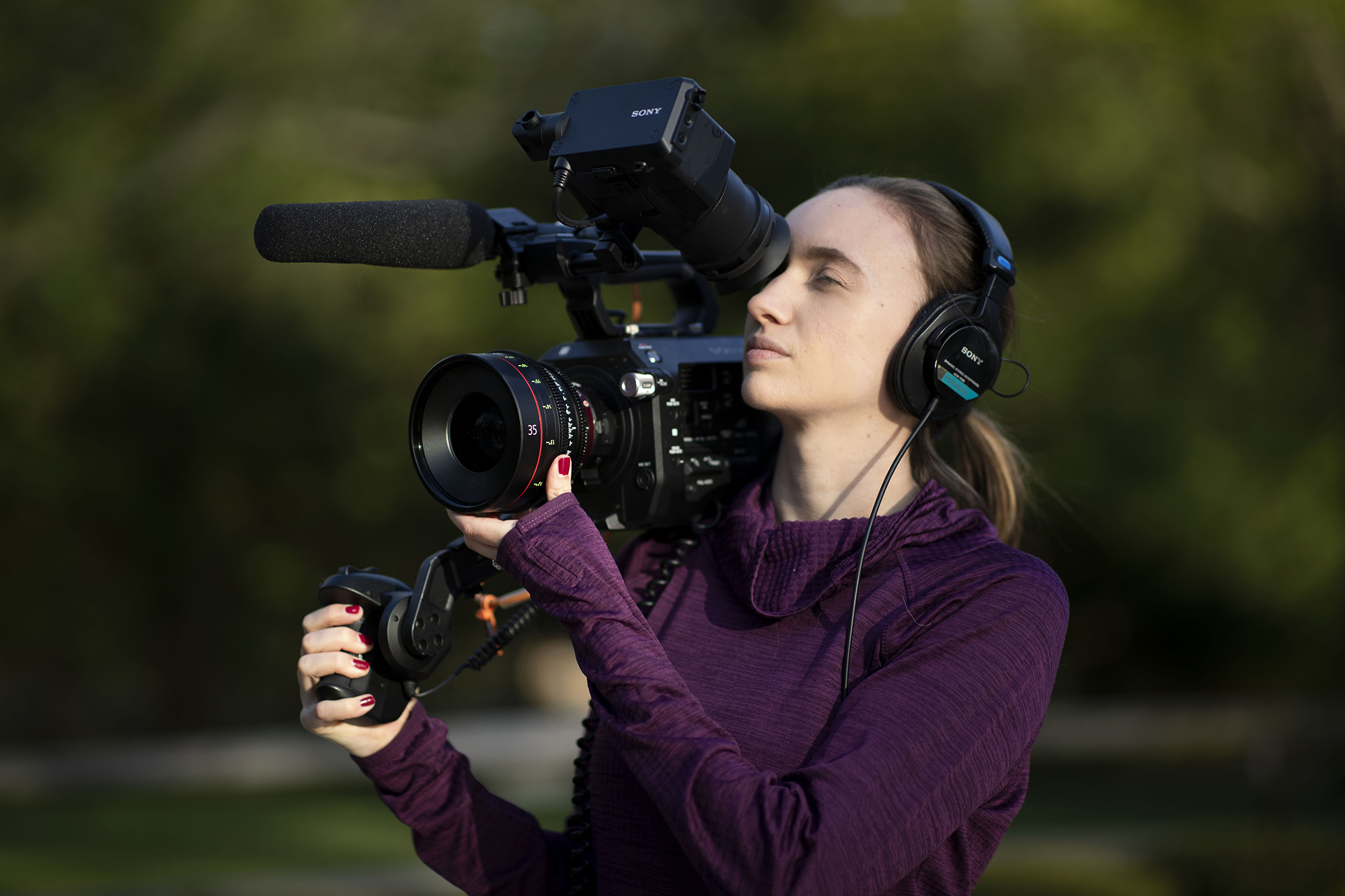 Dominique Hessert working in the field, operating a camera.