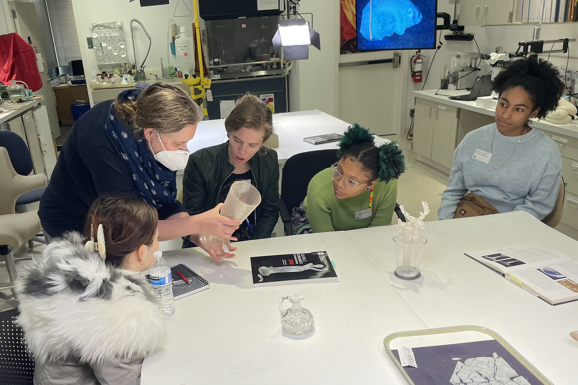 A group of artists gather around a table.