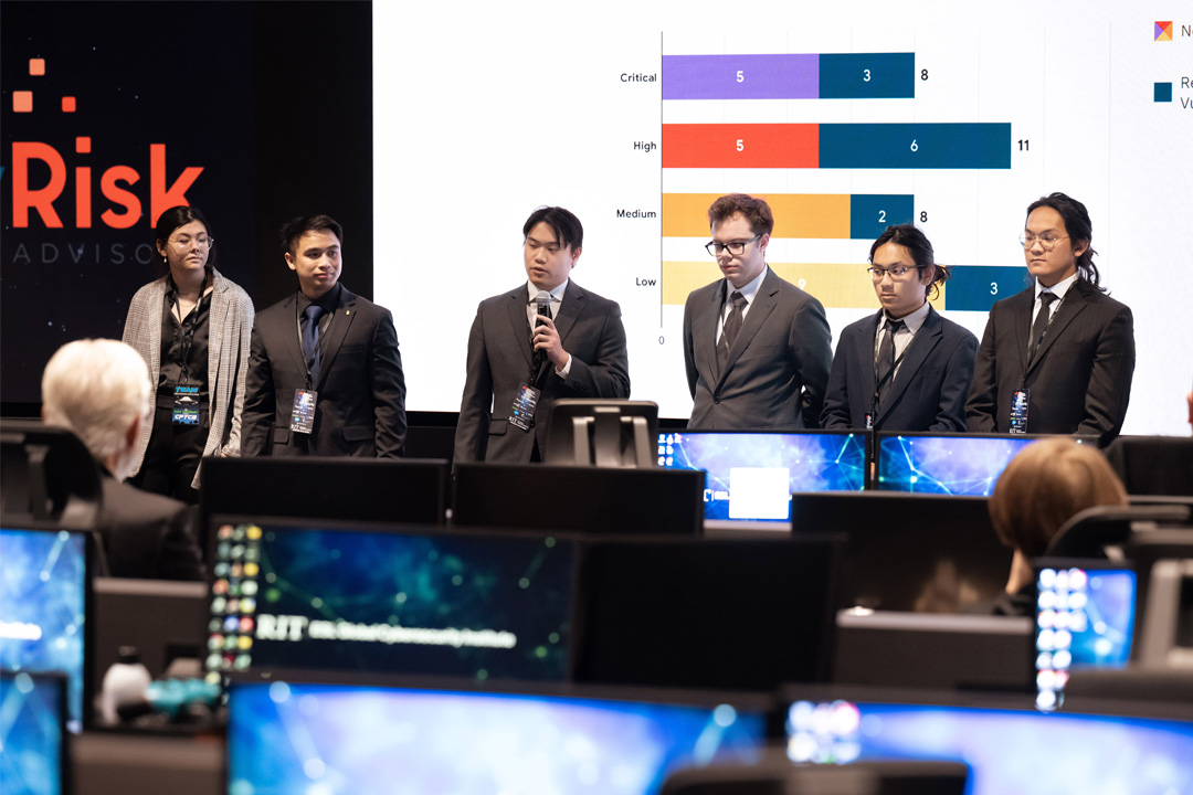 six college students wearing professional attire standing at the front of a room.