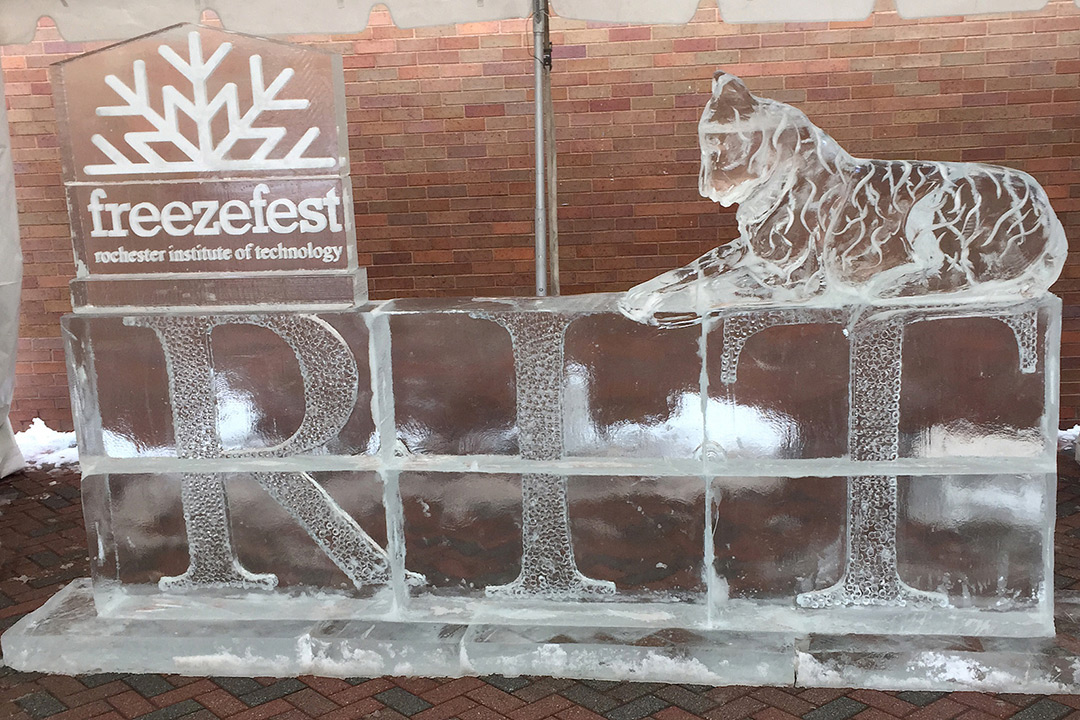 ice sculpture with a tiger and the RIT logo and freeze fest snowflake logo.