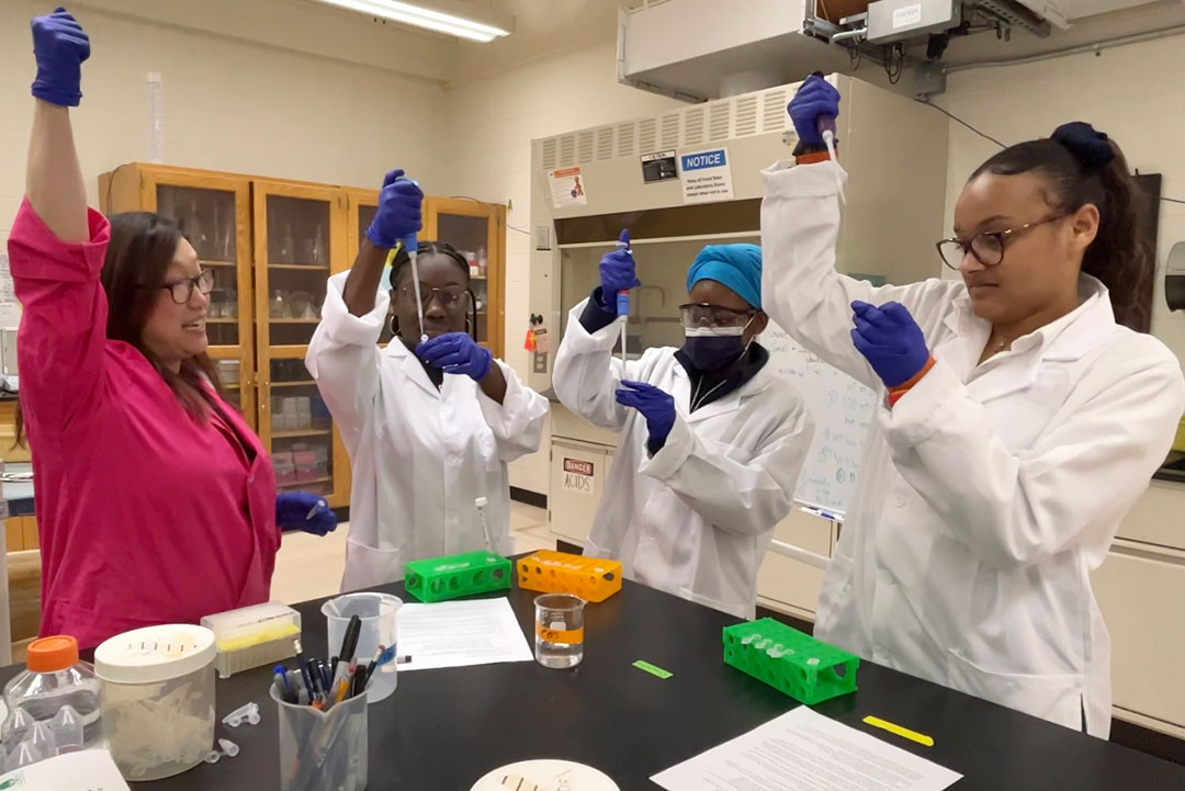 Three Rochester Prep students work with Dr. Lea Michel in her lab at RIT