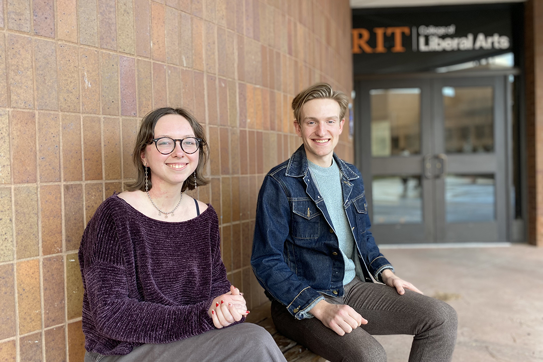 Emma Nastro, left, and Lee Sortore, right, sitting on a bench outside of Liberal Arts Hall.