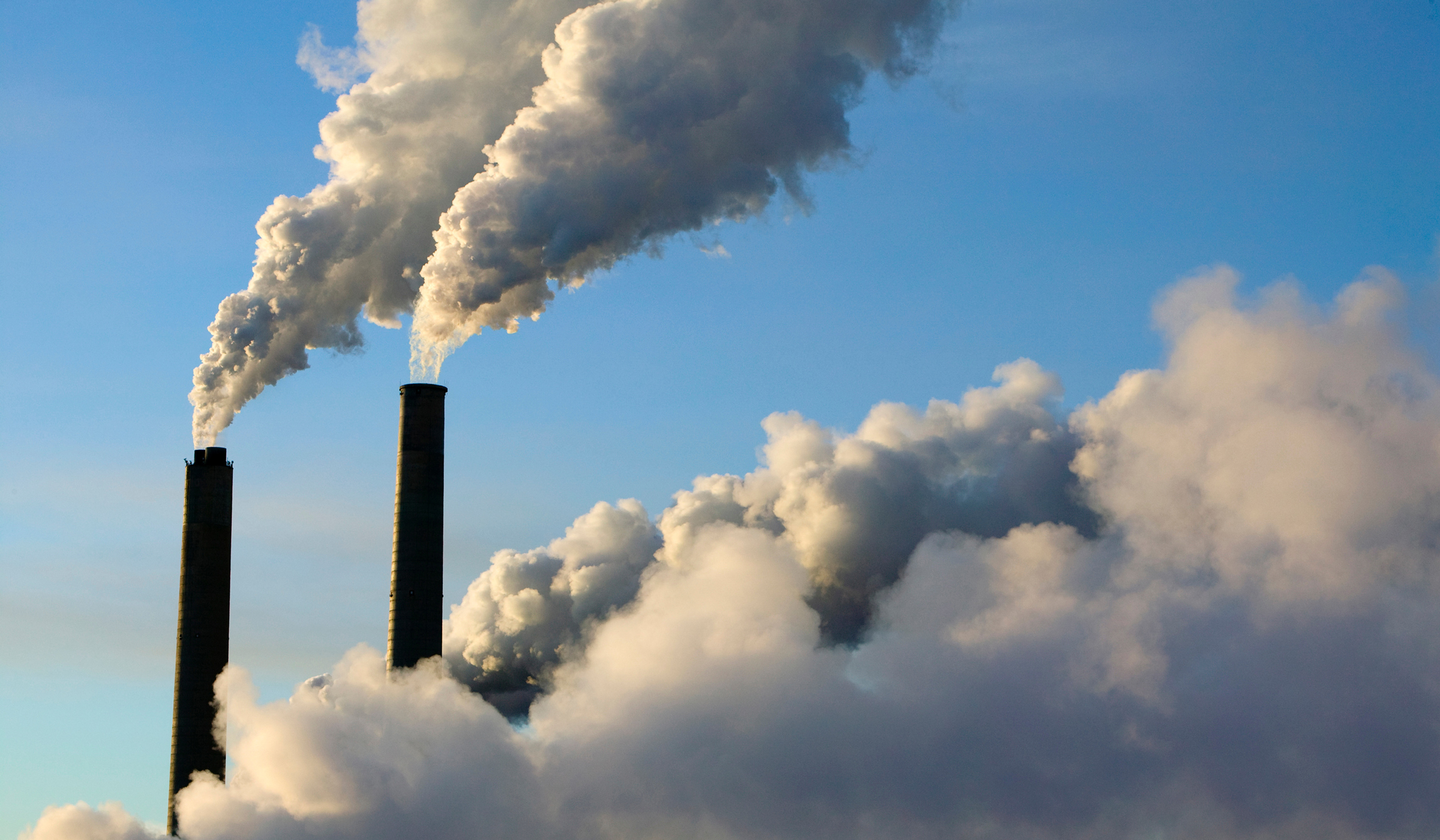 Gas emissions are seen entering the atmosphere from a factory's smokestacks.