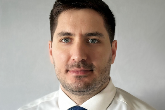 A headshot of RIT Ph.D. alumnus, Dimitris Chachlakis wearing a white collared shirt and blue tie.