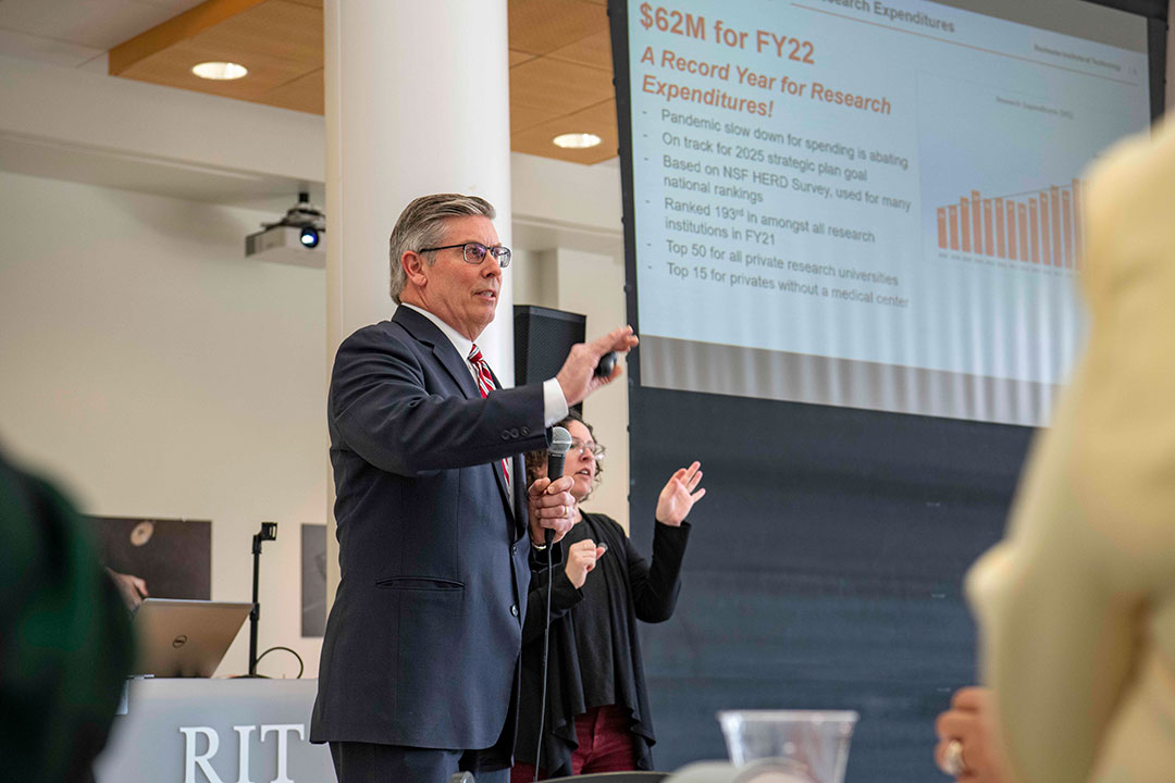 person holding a microphone giving a presentation.