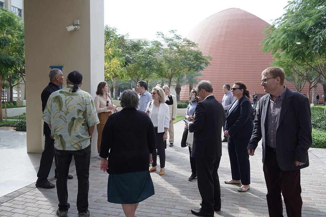 group of people standing outside on the R I T Dubai campus.