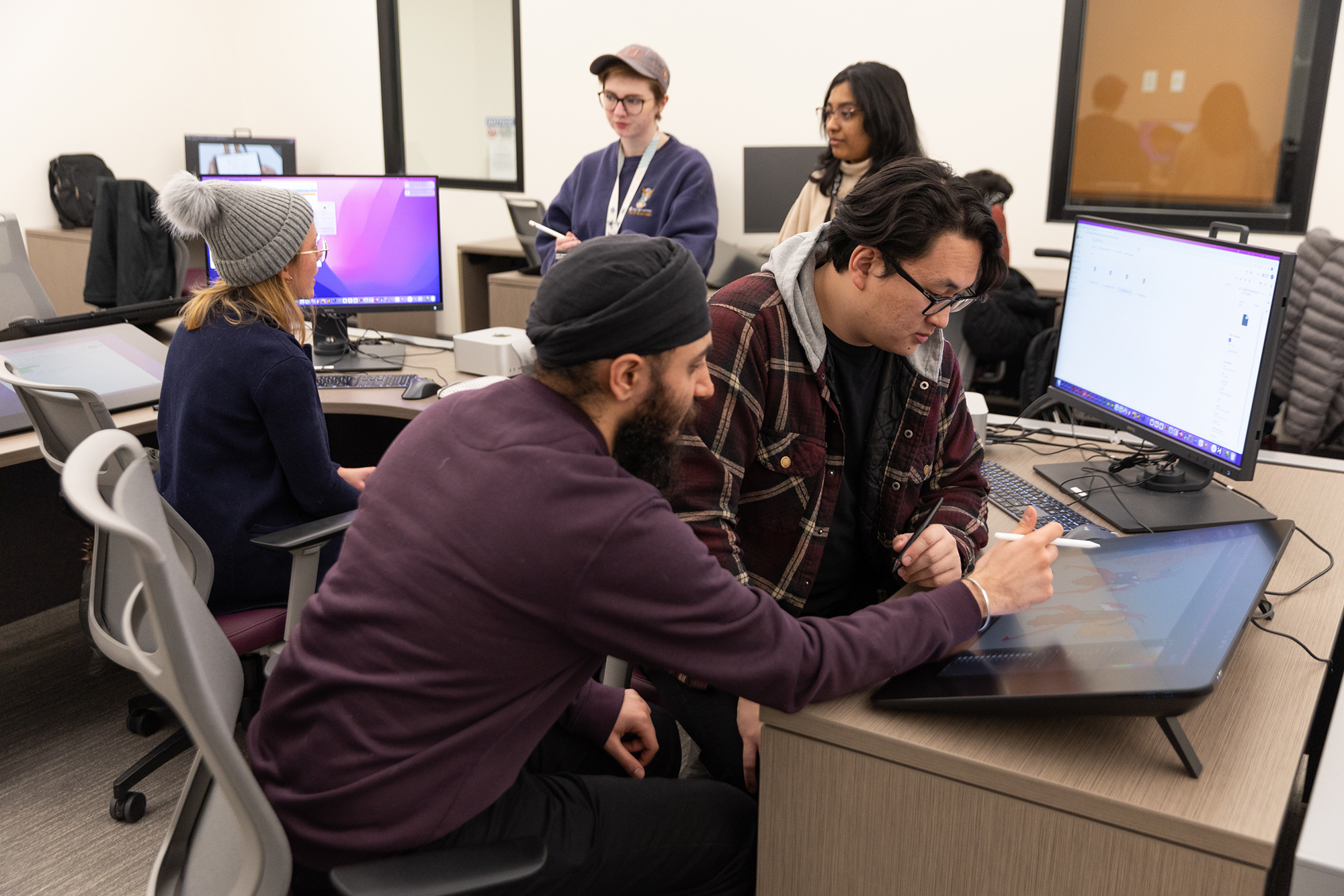 Graduate students collaborate in a lab. 