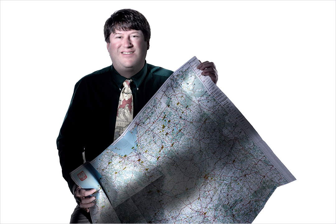 college professor holding a map.
