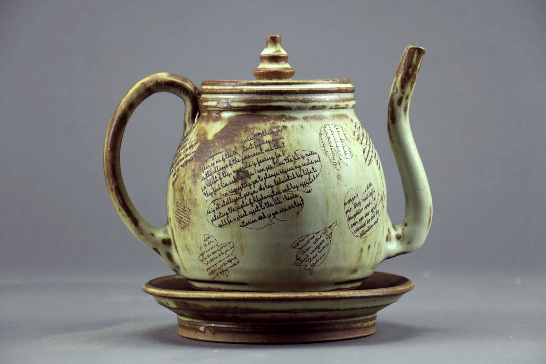 A green teapot with saffron outlines.