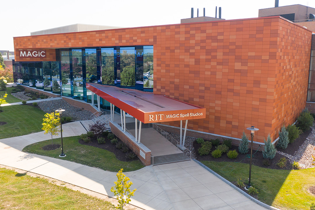 A drone image showing the front of RIT's MAGIC Center on a sunny day.