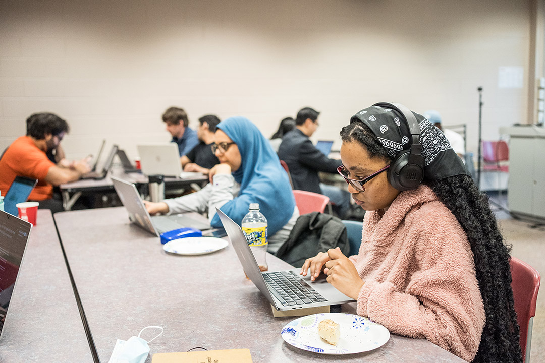 international college students working on laptops.