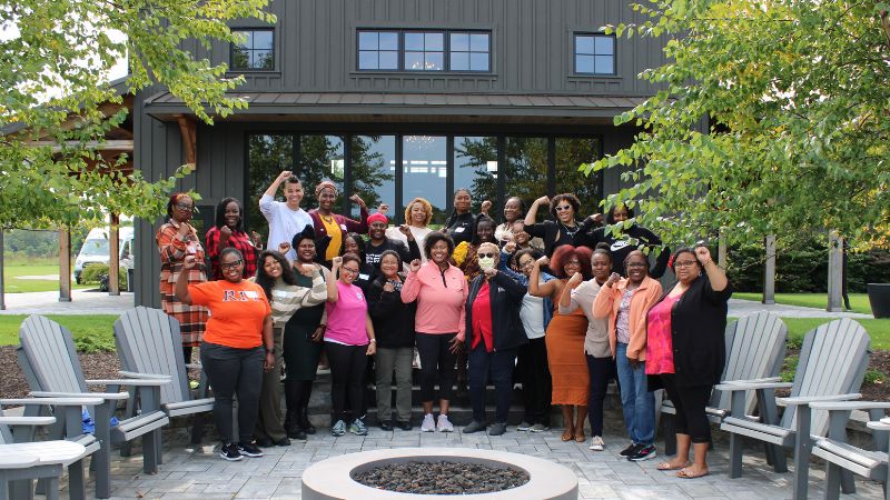 a photo of women gathered in front of the tait preserve during the sisters connect writing retreat in september