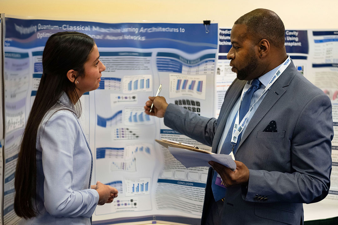 A student talking to a judge about her research project