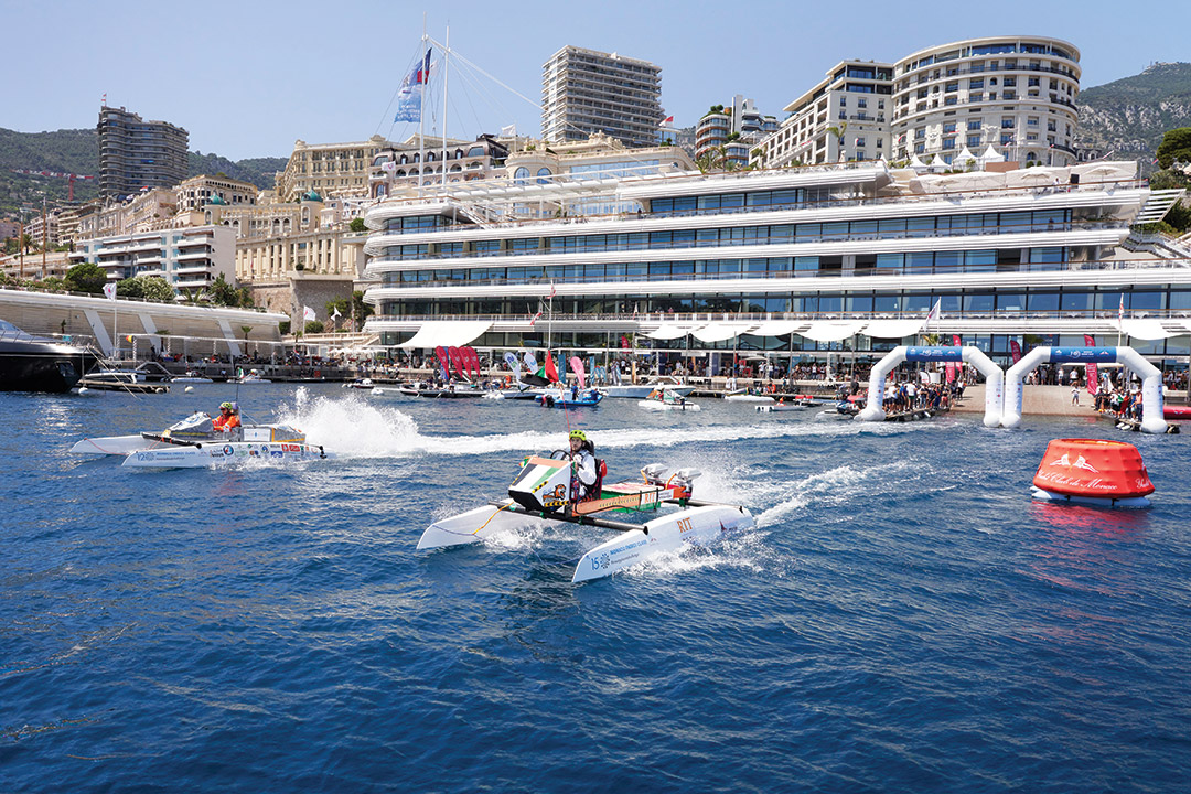 student race pontoon boats in a body of water outside Monaco.
