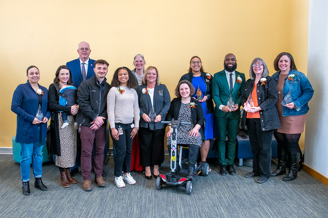 Several RIT staff members, pictured with RIT President David Munson, were recognized for their dedication and service at the annual Presidential Awards for Outstanding Staff on March 28. 
