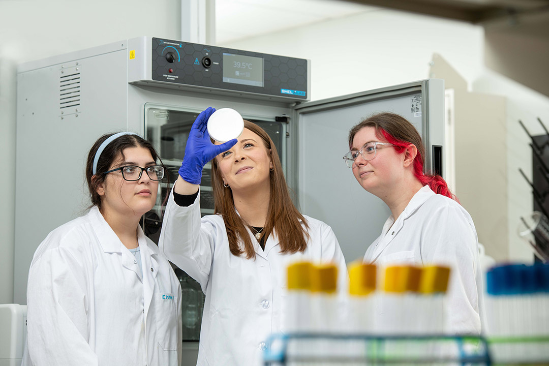 Assistant Professor Elle Barnes is shown working in the state-of-the-art genomics lab with students Emma Thompson and Hannah Zarum