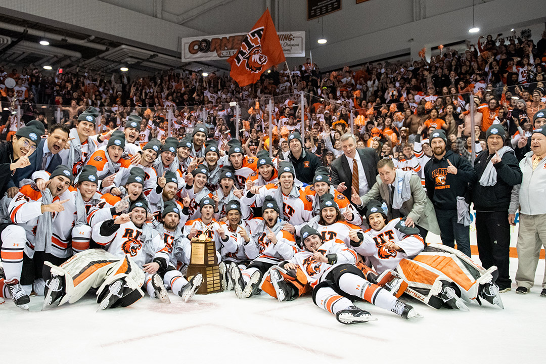 an image of the RIT mens hockey team on the ice after winning the championship.