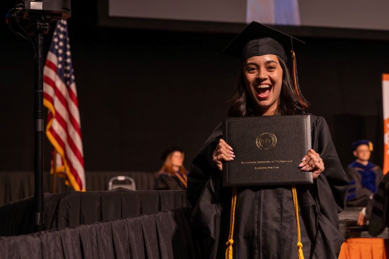 Student walking across stage