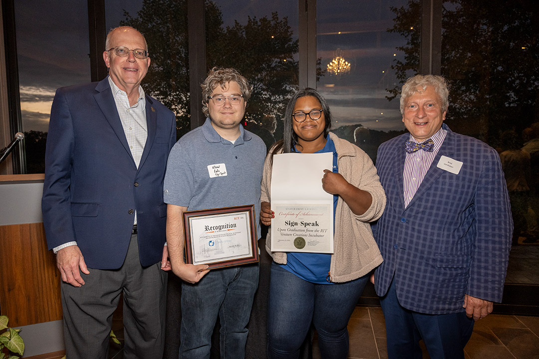 R I T president David Munson stands next to Yamillet Payano and Nikolas Kelly, center, co-founders of startup company Sign-Speak, along with  Venture Creations coach Brad VanAuken.