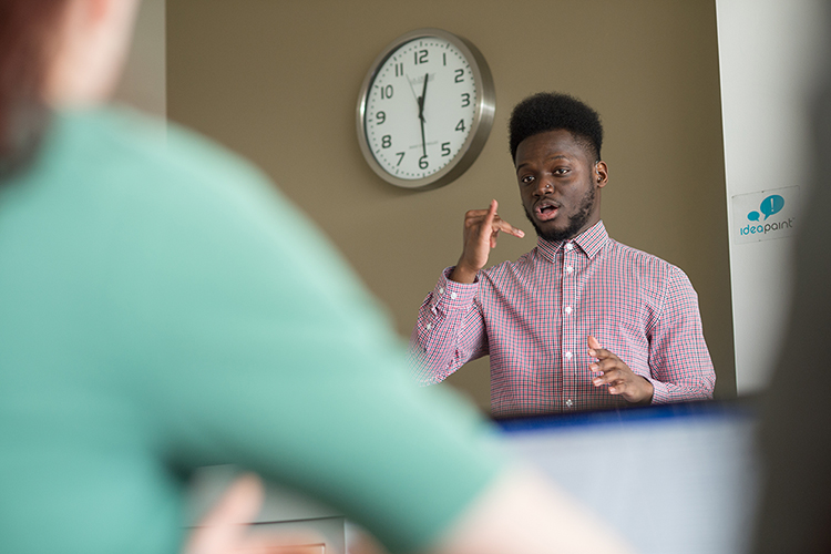 Student presenting in American Sign Language.