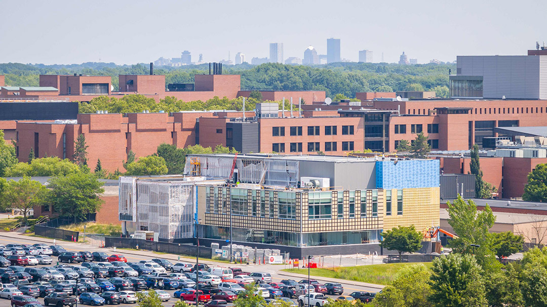 R I T new research building appears on campus with the city of Rochester New York in the background.