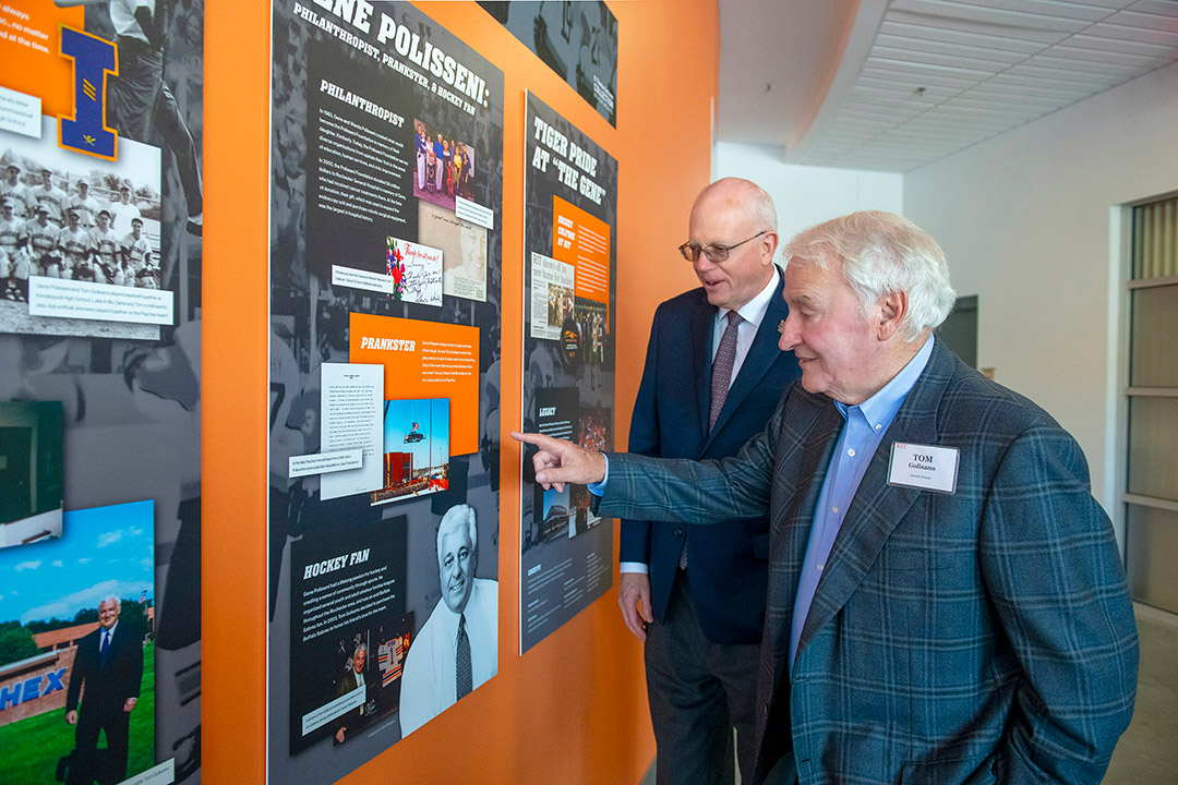 RIT President David Munson and Thomas Golisano stand in front of an exhibit in Golisanos honor