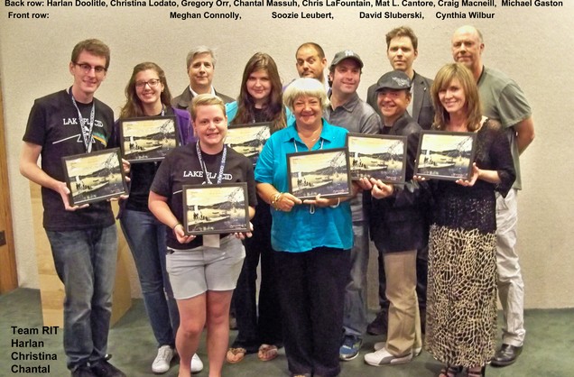 A group of 12 students stand for a group picture holding all of their awards, with the 4 RIT winners among them