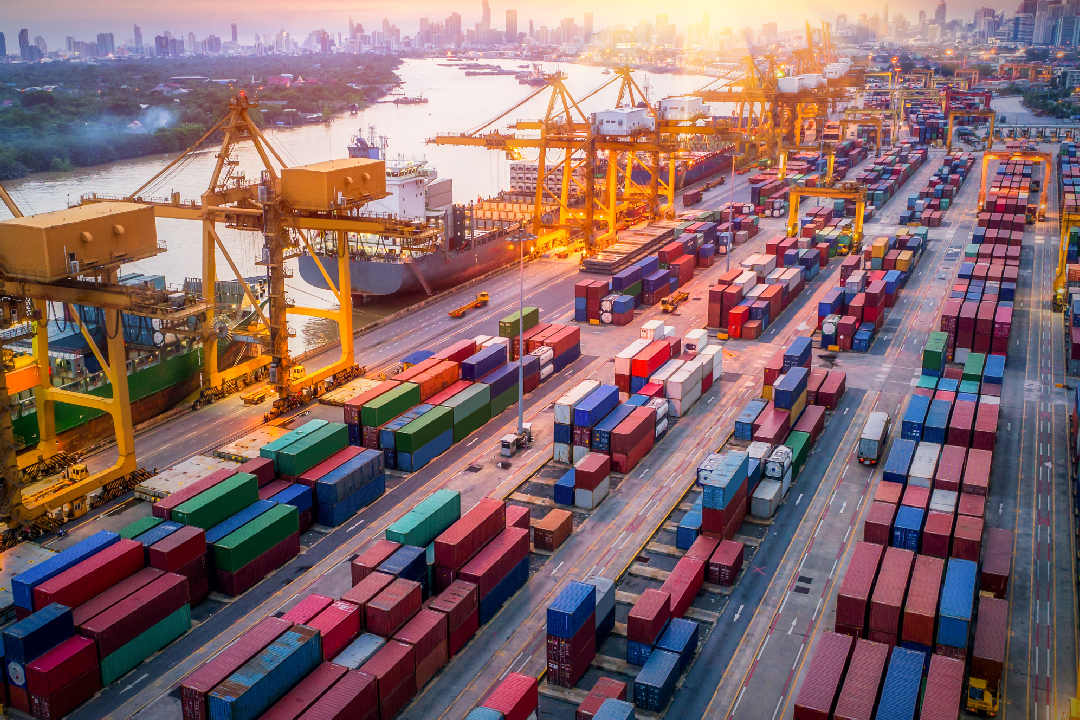 An aerial view of large shipping containers at a port. 